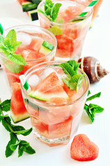 Refreshing summer watermelon drink with mint and ice cubes sea shells, selective focus