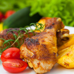Fried chicken legs with tomato and potato