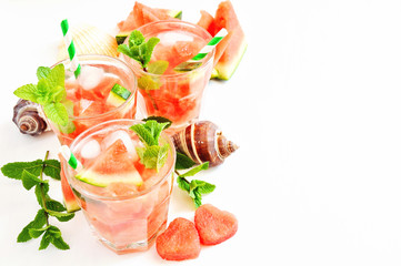 Refreshing summer watermelon drink with mint and ice cubes, sea shells, selective focus