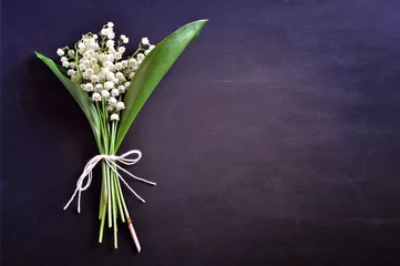 Fototapete Blumen Bouquet of lily of the valley flowers on dark background, copy space