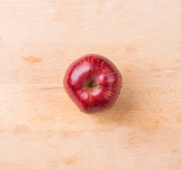 Red apple over wooden background