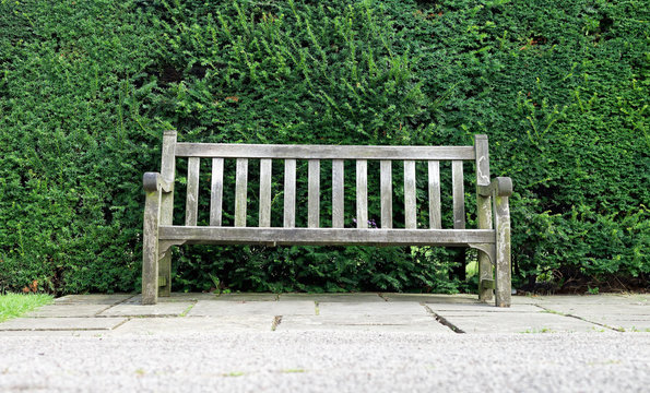 Old weathered wooden bench in park