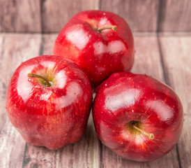 Red apples on weathered wooden background