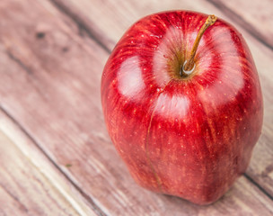 Red apples on weathered wooden background