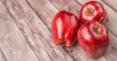 Red apples on weathered wooden background