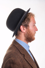 Profile of a bearded man in an old-fashioned Victorian bowler