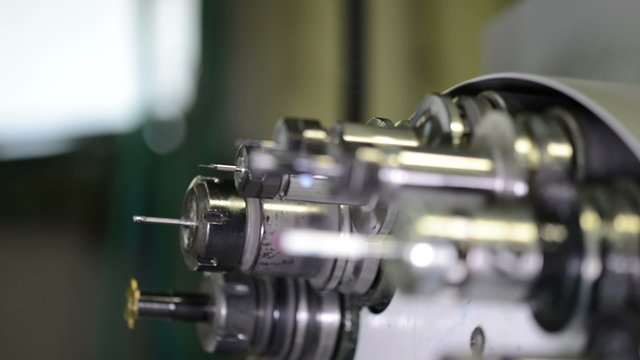 Automatic tool changer rotating bits with tools at CNC lathe milling center