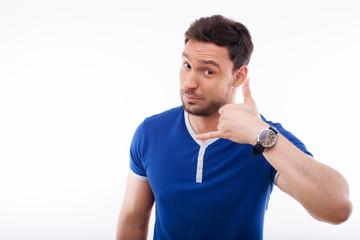 Attractive young guy is gesturing positively and nicely