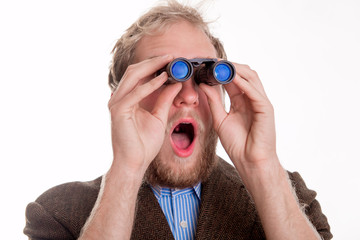 Shocked man watching through binoculars
