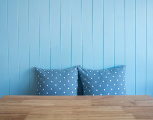 Blue wooden wall background with polkadot pillows and foreground