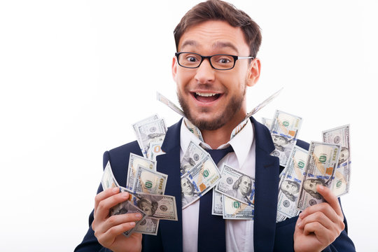 Attractive young man in suit and glasses with cash