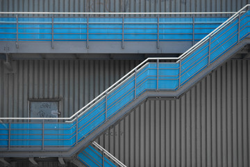 Industrial stairs in front of a metal facade