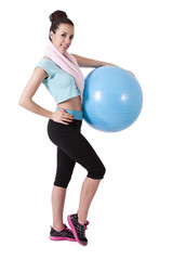 girl in the gym with ball and towel