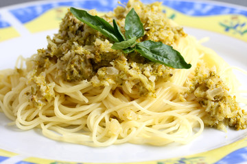 served pasta, spaghetti with cream sauce and zucchini on the plate
