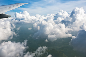 Fototapeta na wymiar Clouds through window of an aircraft