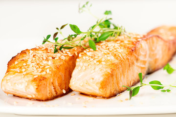 Grilled salmon on white plate