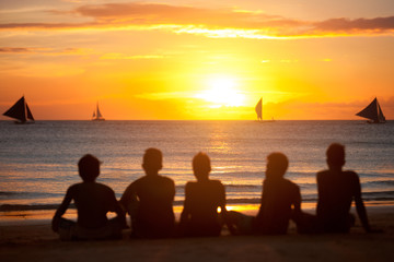 silhouette of group of friends in sunset