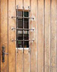 Closed door with barred window.