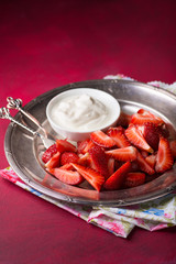 Strawberries on plate with cream