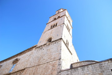 Fototapeta na wymiar Church belfry in Dubrovnik town in Croatia and blue sky