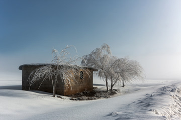 Cottage in a rural area covered with snow