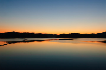 Fototapeta na wymiar blue and orange gradation of sunset on the JINYANG lake