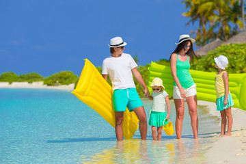 Happy beautiful family on a tropical beach holiday