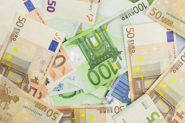 Euro banknotes scattered on the table. Background made with valid euro banknotes.