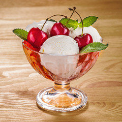 Ice cream with fruits and cherries on boards