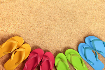 Row line semi circle border of flip flops flipflop summer beach sandals on a sand background team teamwork vacation holiday photo