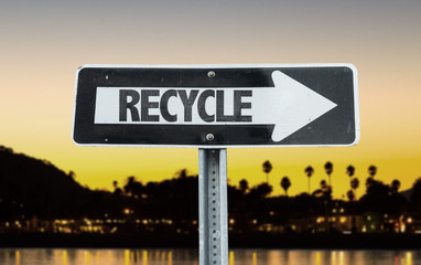 Recycle direction sign with sunset background