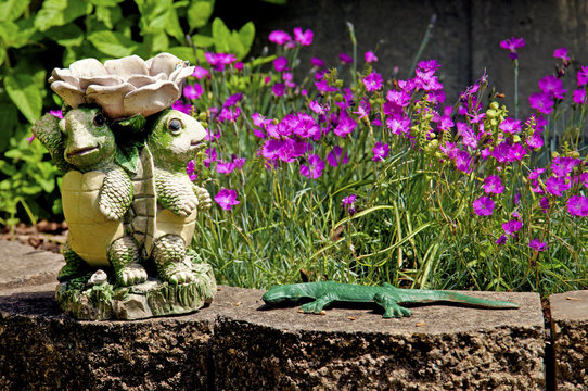 Yard decorations and small purple flowers.