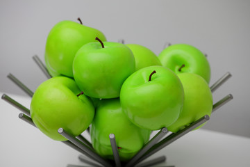 Green apples in a metal vase