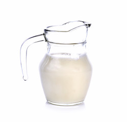 Glass jug of fresh milk isolated on white