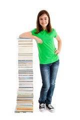 Student standing close to pile of books on white 