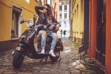 Naklejka premium Casual girl sitting on scooter