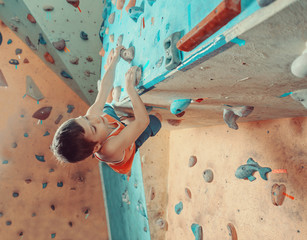 Boy climbing in gym