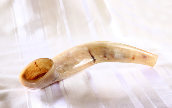shofar (horn) on white prayer talit. rosh hashanah (jewish holiday)