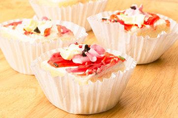 Vanilla cream cake on wooden background
