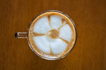cup of cappucino on wooden table