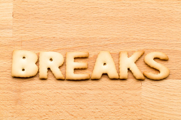 Word break biscuit over the wooden background