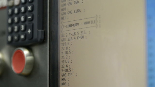 CNC machine monitor display with program code running and numbers changing