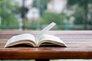 a book on a table, reading at park