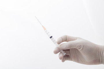 hands holding syringe closeup on white background