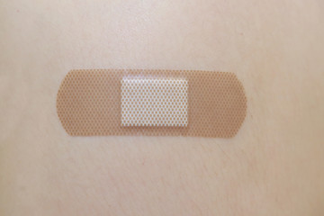 female arm with adhesive bandage