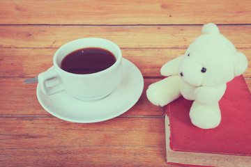 a cup of coffee on a wooden, process color.