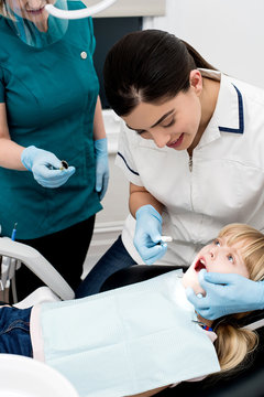 Little girl examined by dentist