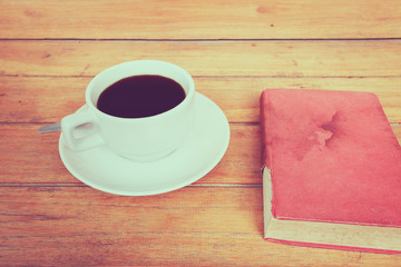 a cup of coffee on a wooden, process color.