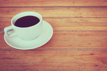 a cup of coffee on a wooden, process color.