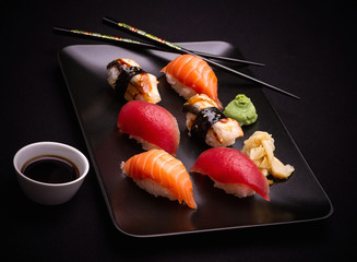 Salmon, tuna and eel sushi with chopsticks